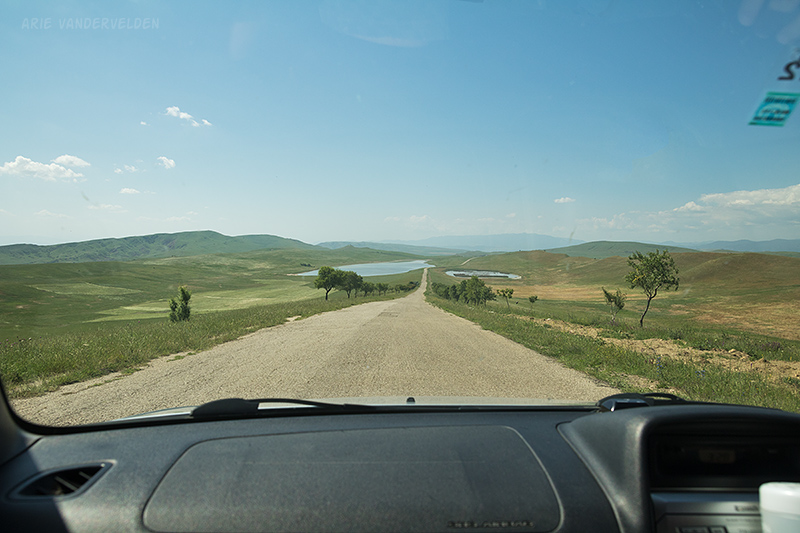 Driving through unfenced open prairie.